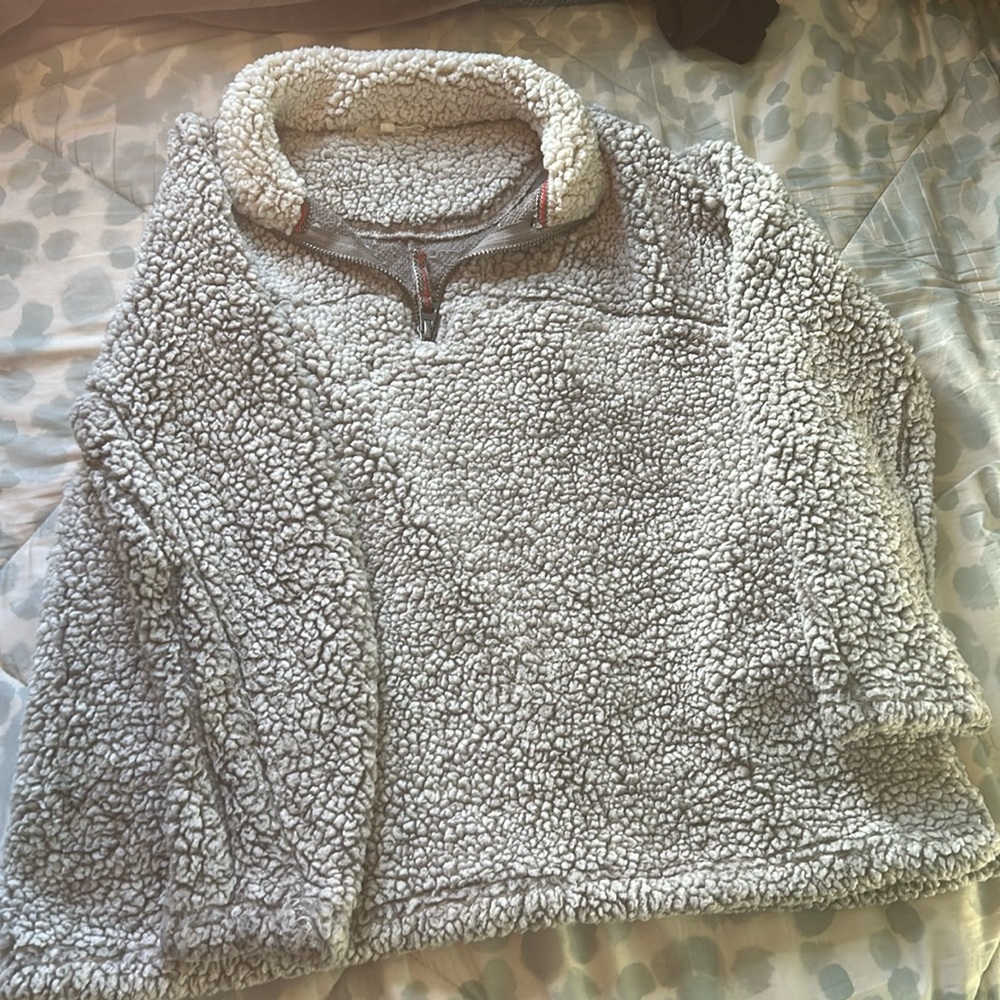 Grey fleece quarter-zip with pockets.